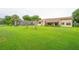 Sprawling backyard featuring well maintained lawn, mature trees and landscaping at 6766 Edgeworth Dr, Orlando, FL 32819
