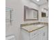Bathroom with decorative mirror, granite countertop, white cabinetry, and modern sink at 6766 Edgeworth Dr, Orlando, FL 32819