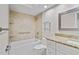 Bathroom featuring tub-shower combo, tiled walls, granite vanity, and updated fixtures at 6766 Edgeworth Dr, Orlando, FL 32819