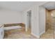Bright bathroom featuring a soaking tub, glass shower, and neutral tile flooring at 6766 Edgeworth Dr, Orlando, FL 32819