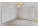 Bedroom featuring neutral carpet, ceiling fan, and large closet with bifold doors at 6766 Edgeworth Dr, Orlando, FL 32819