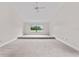 Bright bedroom with neutral carpet and a window offering scenic views of the outdoors at 6766 Edgeworth Dr, Orlando, FL 32819