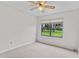 Bedroom with large window and view of the back yard at 6766 Edgeworth Dr, Orlando, FL 32819