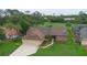 This home's aerial view shows a well-kept lawn and garden, an attached three car garage, and mature landscaping at 6766 Edgeworth Dr, Orlando, FL 32819