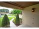 View of manicured landscaping and front walk from the covered front porch at 6766 Edgeworth Dr, Orlando, FL 32819