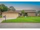 Charming single-story home featuring a three-car garage and lush, green lawn at 6766 Edgeworth Dr, Orlando, FL 32819