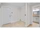 Hallway view leading to bathroom, tiled floor, and white trim at 6766 Edgeworth Dr, Orlando, FL 32819