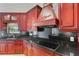 Close-up on gourmet kitchen with granite countertops, stainless steel appliances, and custom cabinetry at 6766 Edgeworth Dr, Orlando, FL 32819