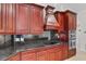 Kitchen featuring custom cabinets, granite countertops, stainless steel appliances including cooktop and oven at 6766 Edgeworth Dr, Orlando, FL 32819