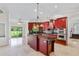 Gourmet kitchen features custom cabinets, granite countertops, stainless steel appliances, and a spacious center island at 6766 Edgeworth Dr, Orlando, FL 32819