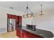 Spacious kitchen featuring custom cabinets, granite countertops, and a central island with ample countertop space at 6766 Edgeworth Dr, Orlando, FL 32819