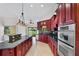 Spacious kitchen featuring a large island, stainless steel appliances, and backyard views at 6766 Edgeworth Dr, Orlando, FL 32819
