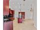 Open kitchen with island, stainless appliances, and custom cabinetry at 6766 Edgeworth Dr, Orlando, FL 32819