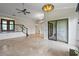 Bright living room boasts tile floors, staircase, and sliding glass doors for seamless indoor-outdoor living at 6766 Edgeworth Dr, Orlando, FL 32819