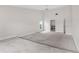 Open main bedroom boasting plush carpet, and a door leading to the ensuite bath at 6766 Edgeworth Dr, Orlando, FL 32819