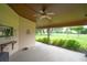 Covered patio with a ceiling fan with an open view to the beautiful green yard at 6766 Edgeworth Dr, Orlando, FL 32819