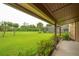 Covered patio with great views of the spacious backyard, screen enclosure and landscaping at 6766 Edgeworth Dr, Orlando, FL 32819
