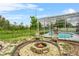 Relaxing backyard with screened-in pool area, comfortable seating, and inviting fire pit for outdoor enjoyment at 701 Little Hampton Ln, Gotha, FL 34734