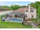 Backyard view of screened-in pool, fire pit, and well-manicured lawn at 701 Little Hampton Ln, Gotha, FL 34734