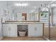 Large bathroom featuring dual sinks, stone countertops, and glass enclosed shower at 701 Little Hampton Ln, Gotha, FL 34734