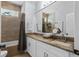 Bathroom vanity with white cabinets, granite countertops and a soaking tub at 701 Little Hampton Ln, Gotha, FL 34734