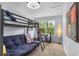 Modern bedroom with a bunk bed, desk, and cozy seating, creating a functional and inviting space at 701 Little Hampton Ln, Gotha, FL 34734