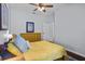 Bedroom with yellow comforter, wood flooring, dresser and interior door at 701 Little Hampton Ln, Gotha, FL 34734
