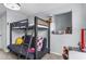 Well-furnished bedroom with a bunk bed, desk, and cozy seating, creating a comfortable and inviting space at 701 Little Hampton Ln, Gotha, FL 34734