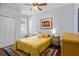 Comfortable bedroom with yellow comforter, ceiling fan and matching end tables at 701 Little Hampton Ln, Gotha, FL 34734