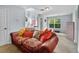 Comfortable bonus room showcasing a cozy couch, natural light, and a functional desk area at 701 Little Hampton Ln, Gotha, FL 34734