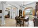 Bright dining room featuring a large window, modern light fixture, and dining table at 701 Little Hampton Ln, Gotha, FL 34734