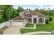 Beautifully landscaped home boasts a spacious front yard, well-manicured lawn, and attached two-car garage at 701 Little Hampton Ln, Gotha, FL 34734