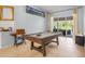 Entertaining game room featuring a pool table and sliding glass doors to the outdoor pool at 701 Little Hampton Ln, Gotha, FL 34734