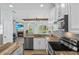 Charming kitchen with granite countertops, stainless steel appliances, and backsplash with a view to the living room at 701 Little Hampton Ln, Gotha, FL 34734