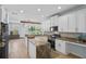 Bright kitchen with white cabinets, granite countertops, stainless steel appliances, and backsplash with island counter at 701 Little Hampton Ln, Gotha, FL 34734
