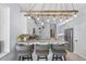 Eat-in kitchen featuring a marble breakfast bar with pendant lighting and seating for three at 701 Little Hampton Ln, Gotha, FL 34734