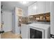 Well-organized laundry room featuring modern washer and dryer, ample storage, and stylish accent wall at 701 Little Hampton Ln, Gotha, FL 34734