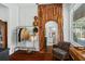 Cozy living room space with decorative archway, coat rack, and comfortable armchair at 701 Little Hampton Ln, Gotha, FL 34734