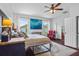 Relaxing main bedroom with a ceiling fan, and large windows at 701 Little Hampton Ln, Gotha, FL 34734