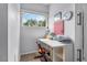 Cozy office with a built in white desk, window, and neutral carpet at 701 Little Hampton Ln, Gotha, FL 34734