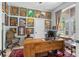 Inviting home office with large windows, a wooden desk, and unique wall art at 701 Little Hampton Ln, Gotha, FL 34734