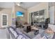 Inviting outdoor living space with comfortable seating, ceiling fan, and a TV, ideal for relaxing or entertaining guests at 701 Little Hampton Ln, Gotha, FL 34734
