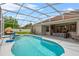 Relaxing screened in-ground pool with table and chairs and outdoor lounge, perfect for entertaining guests at 701 Little Hampton Ln, Gotha, FL 34734