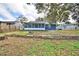 Spacious backyard with a screened-in porch featuring a retaining wall, perfect for outdoor enjoyment at 7504 Willow Wisp E Dr, Lakeland, FL 33810