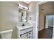 Bathroom with an updated vanity with drawers and cabinets, modern faucet and framed mirror, and neutral paint at 7504 Willow Wisp E Dr, Lakeland, FL 33810