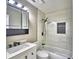 Updated bathroom with modern white tiled walls, a shower/tub combo, and modern fixtures at 7504 Willow Wisp E Dr, Lakeland, FL 33810