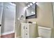 Updated bathroom with modern vanity, toilet and a view of the door to the hallway at 7504 Willow Wisp E Dr, Lakeland, FL 33810