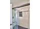 Spa-like shower with black hardware, glass door, large tile surround, and a small tiled window at 7504 Willow Wisp E Dr, Lakeland, FL 33810