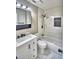 Updated bathroom with modern white tiled walls, a shower/tub combo, and modern fixtures at 7504 Willow Wisp E Dr, Lakeland, FL 33810