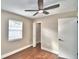 Bedroom features hardwood flooring, ceiling fan, and a closet with wire shelving at 7504 Willow Wisp E Dr, Lakeland, FL 33810
